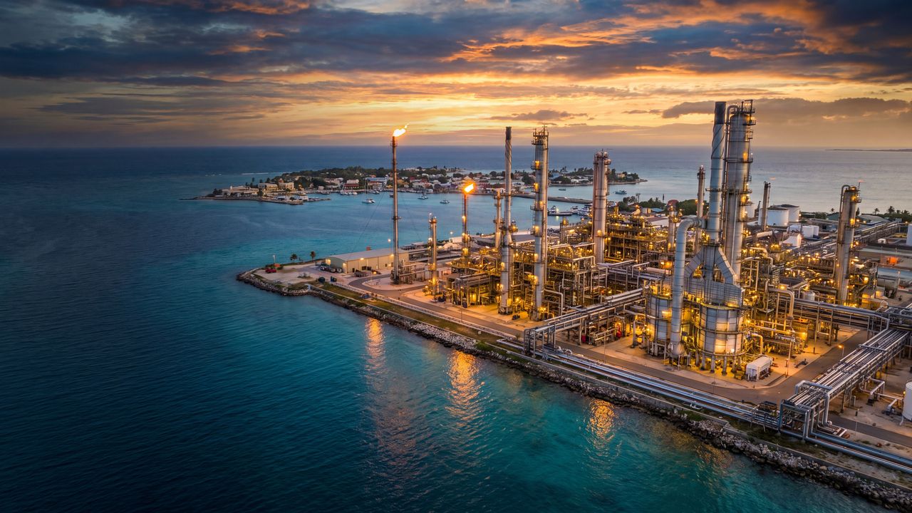 Aerial view of a coastal refinery on a Caribbean island at sunset