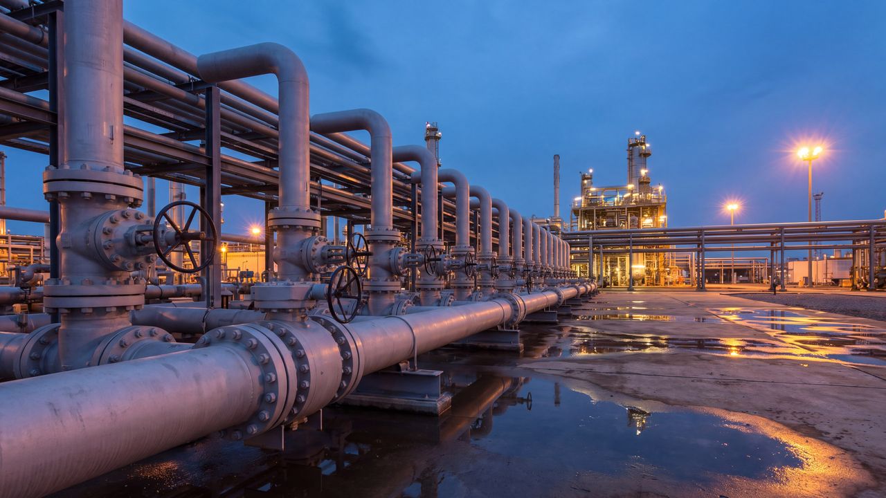 Pipes and valves of a gas plant at dusk